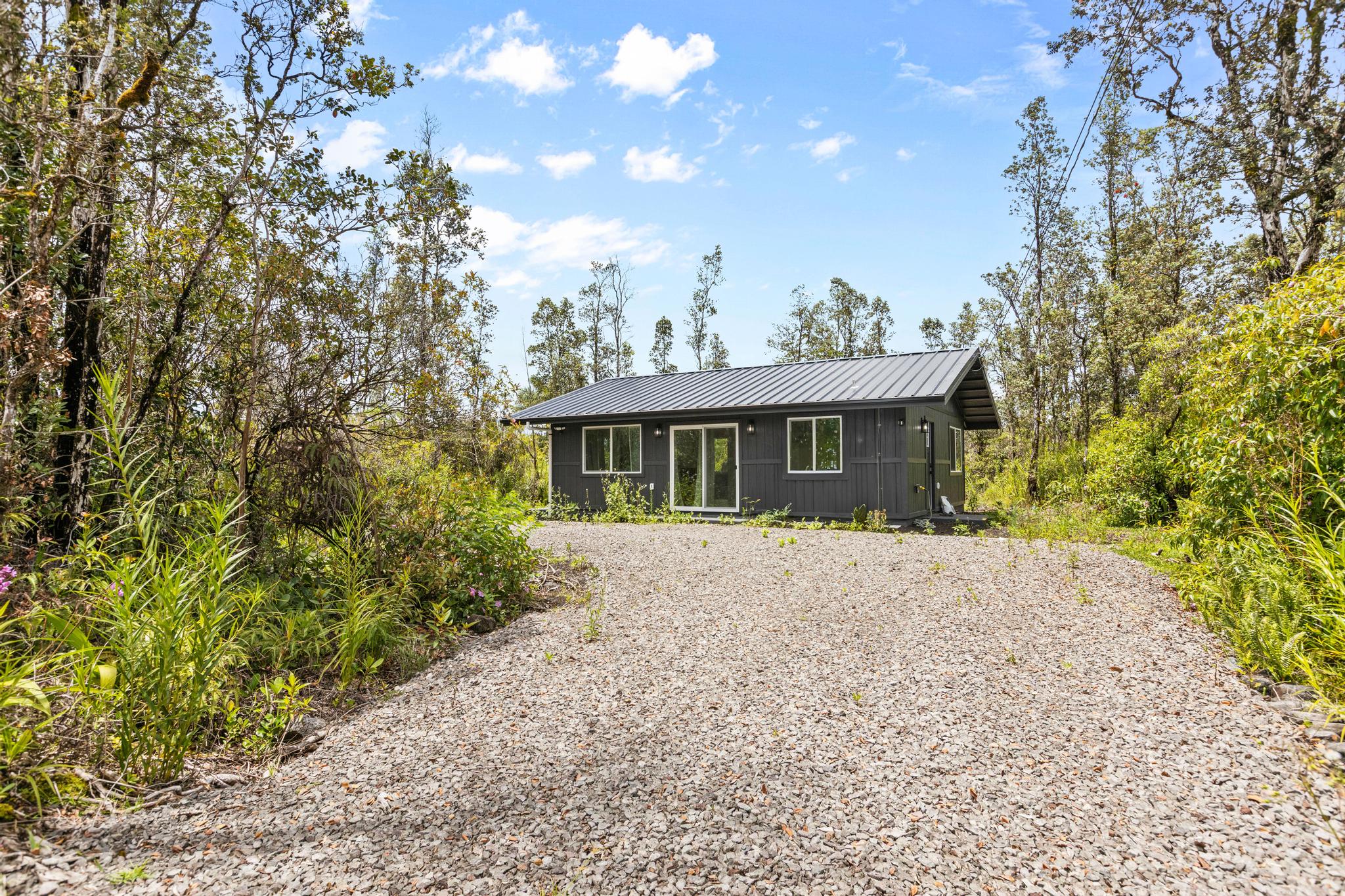 16-2075 Treefern Drive Pahoa, HI 96778 - Photo 1 of 24 a front view of a house with a garden