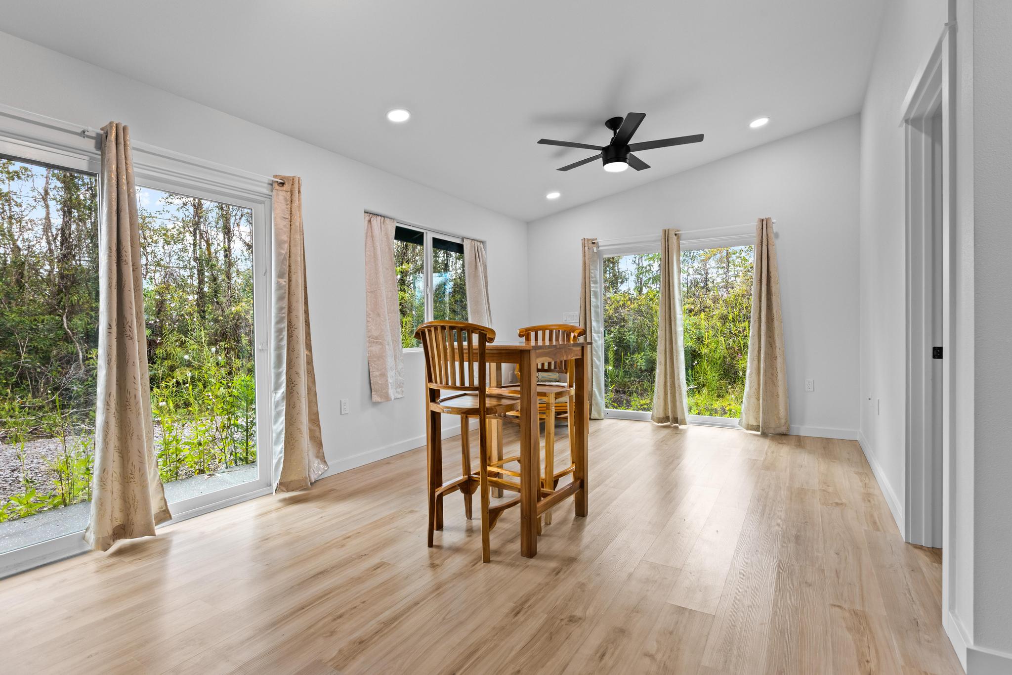 16-2075 Treefern Drive Pahoa, HI 96778 - Photo 4 of 24 a dining room with furniture window wooden floor