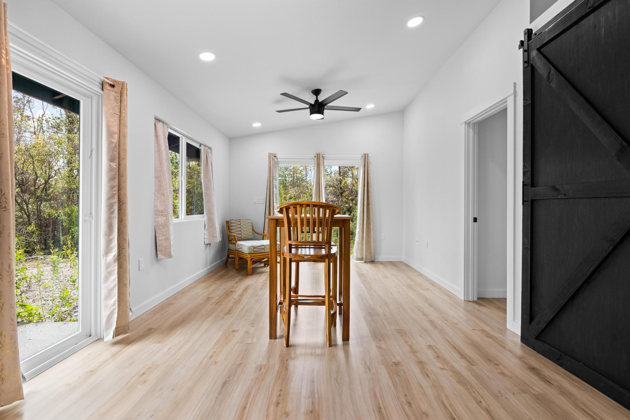 16-2075 Treefern Drive Pahoa, HI 96778 - Photo 5 of 24 a view of a livingroom with furniture wooden floor a ceiling fan and windows