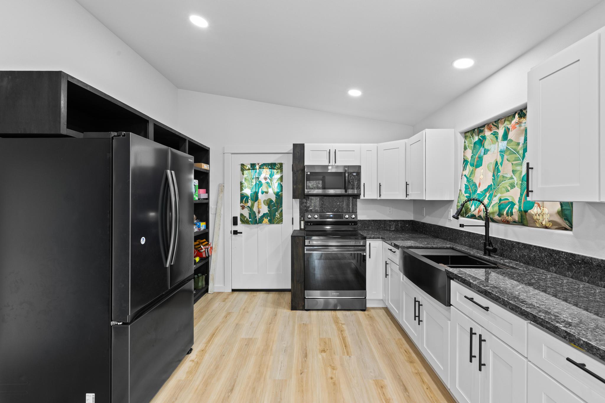 16-2075 Treefern Drive Pahoa, HI 96778 - Photo 7 of 24 a kitchen with stainless steel appliances granite countertop a refrigerator and a sink