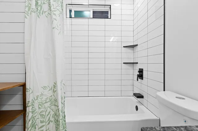 a bathroom with a bathtub and shower