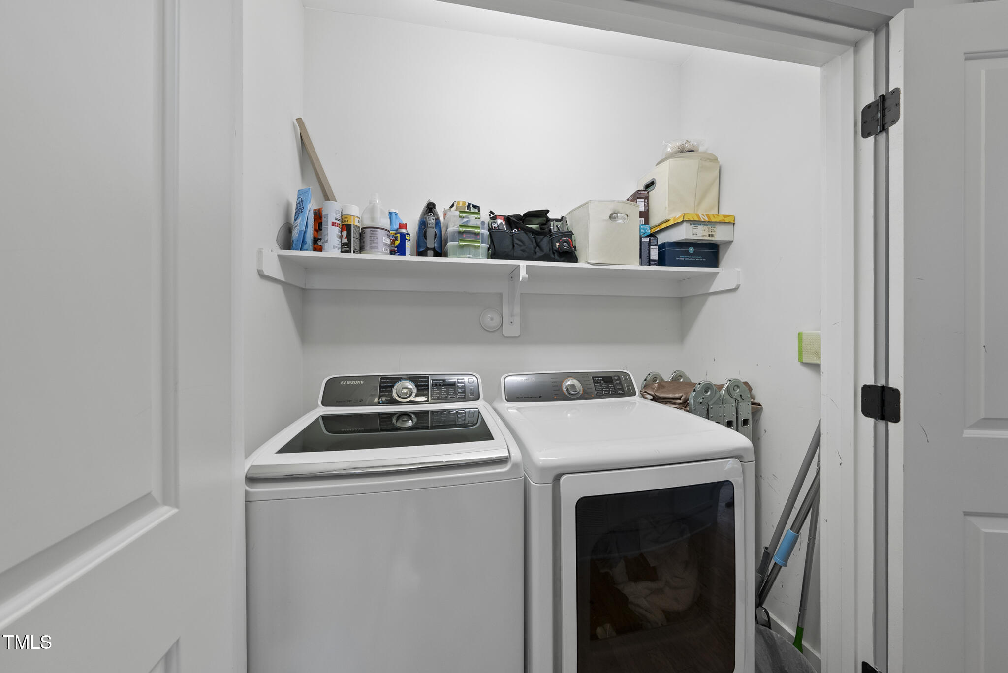 1010 South Person Street Raleigh, NC 27601 - Photo 22 of 41 a utility room with dryer washer and a view of living room