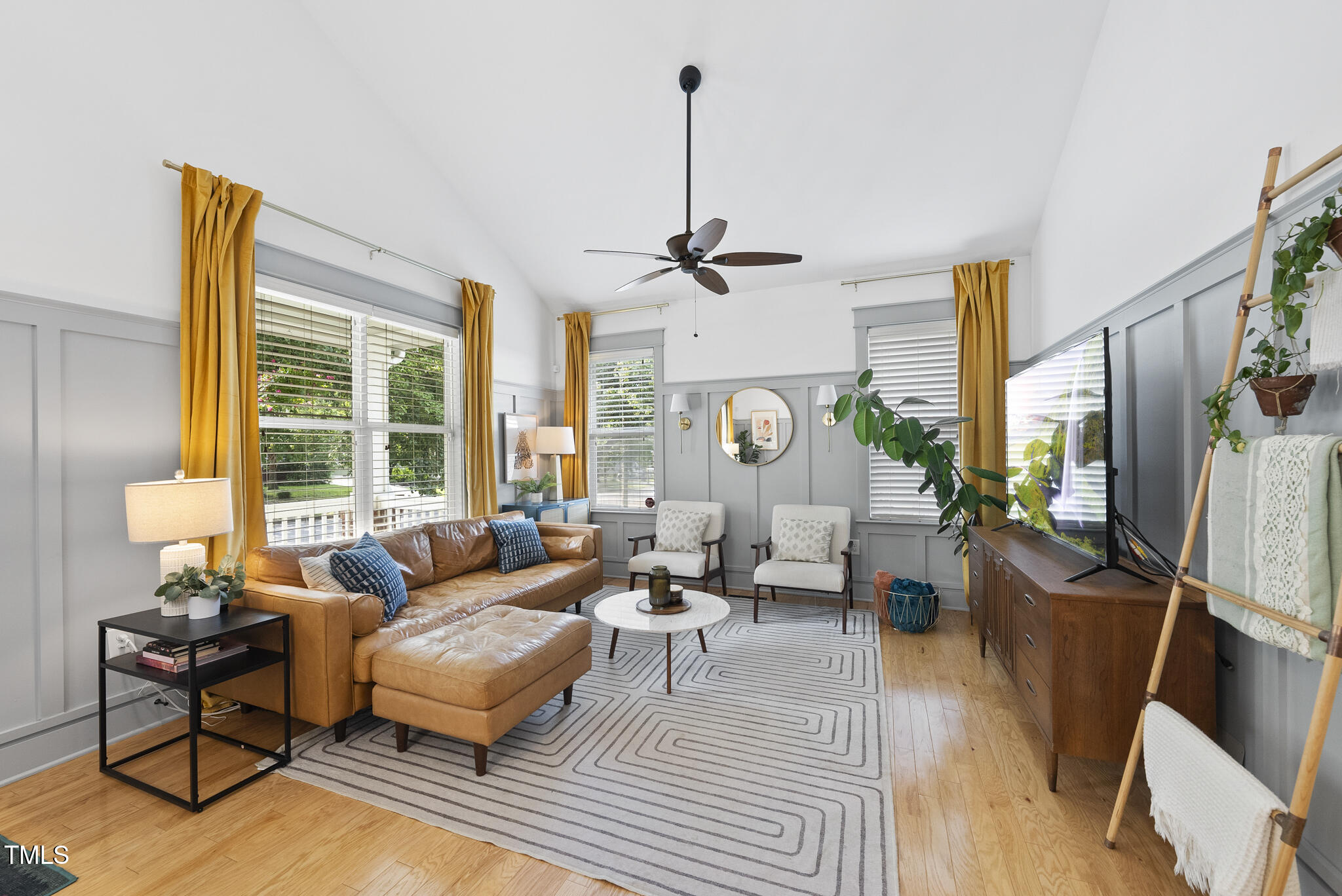 1010 South Person Street Raleigh, NC 27601 - Photo 3 of 41 a living room with furniture a large window and a chandelier