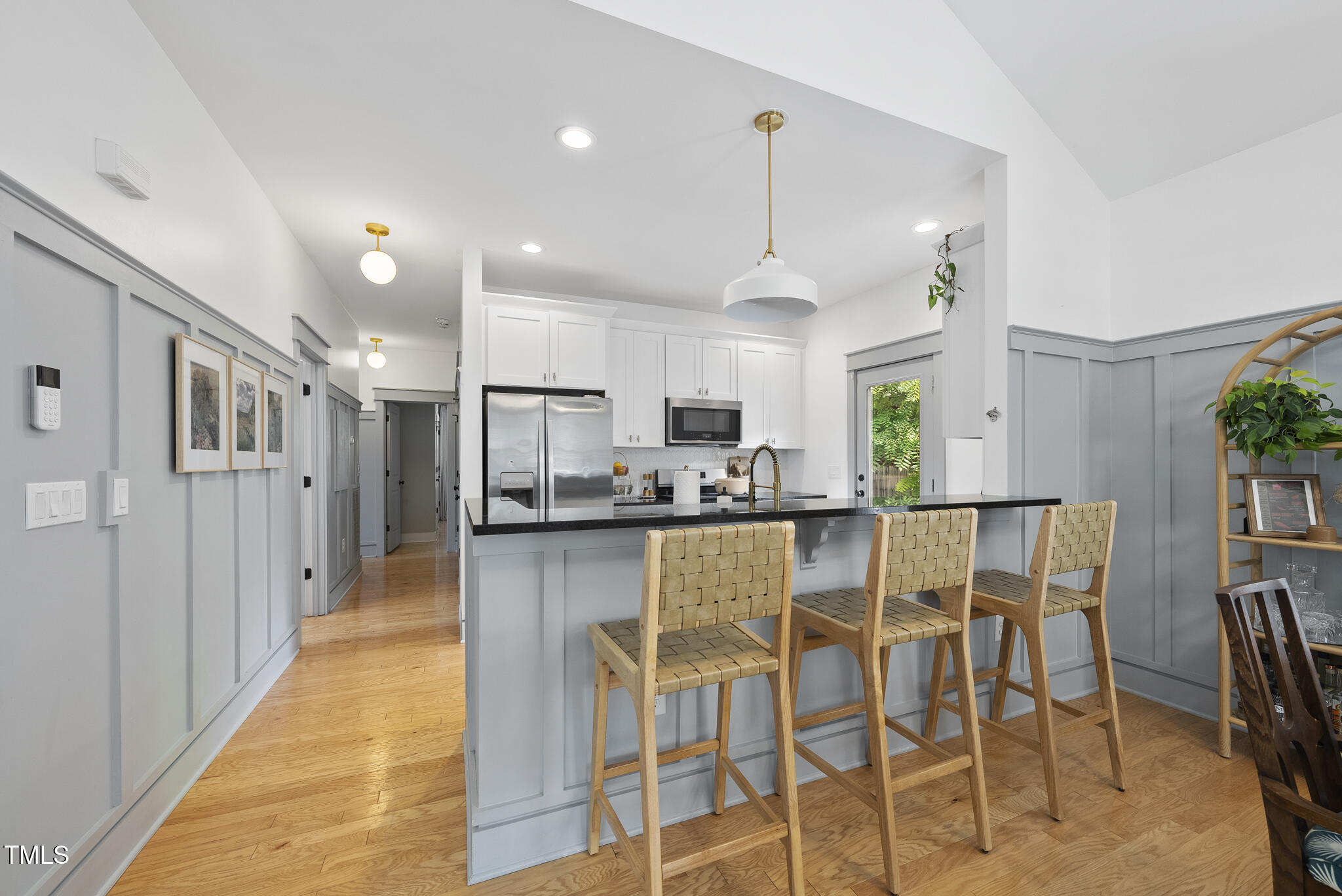 1010 South Person Street Raleigh, NC 27601 - Photo 8 of 41 a kitchen with stainless steel appliances kitchen island granite countertop a dining table chairs and white cabinets