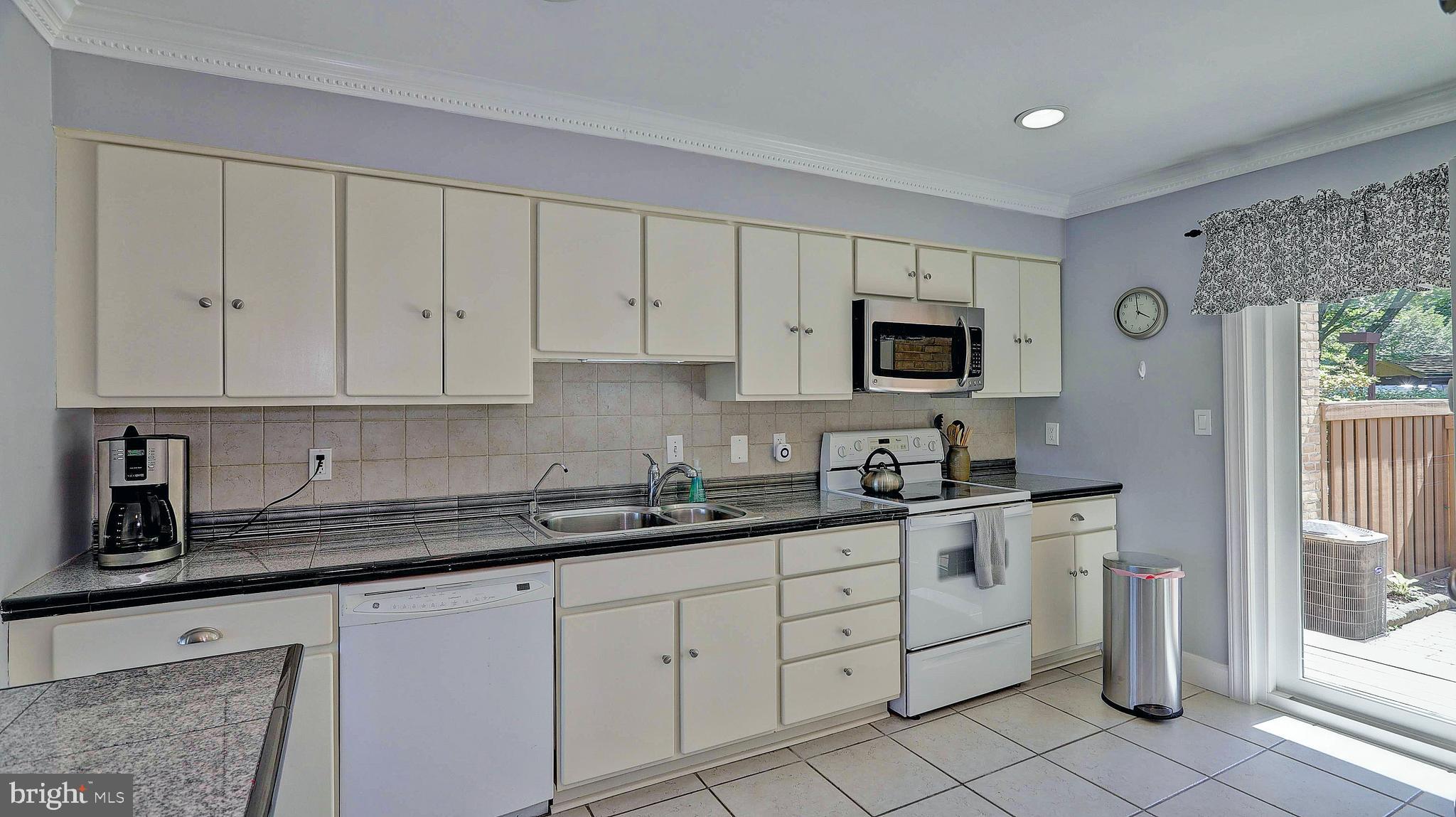 11210 Lagoon Lane Reston, VA 20191 - Photo 12 of 63 Main kitchen with painted cabinets and custom appl