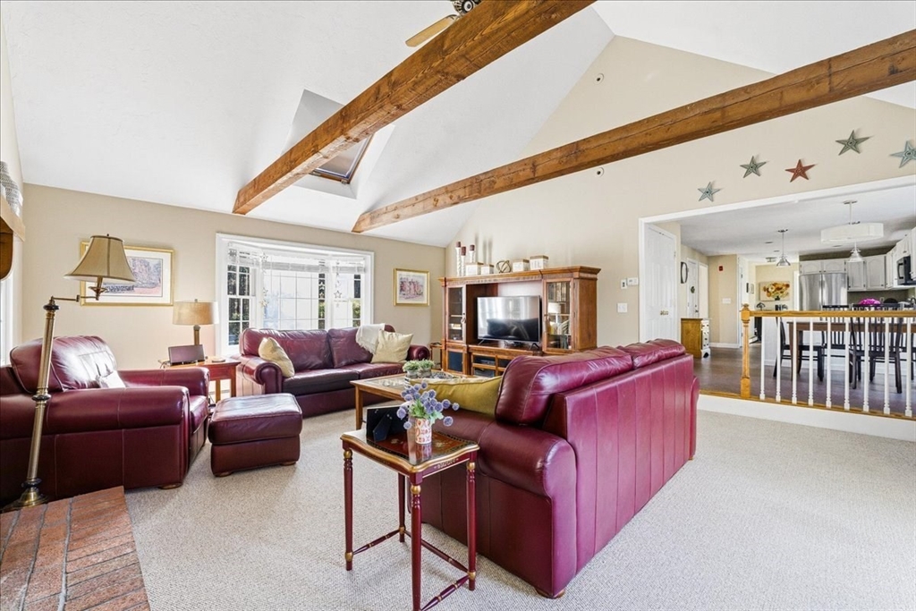 33 1st Parish Lane Hanover, MA 02339 - Photo 12 of 35 a living room with furniture a flat screen tv and a floor to ceiling window