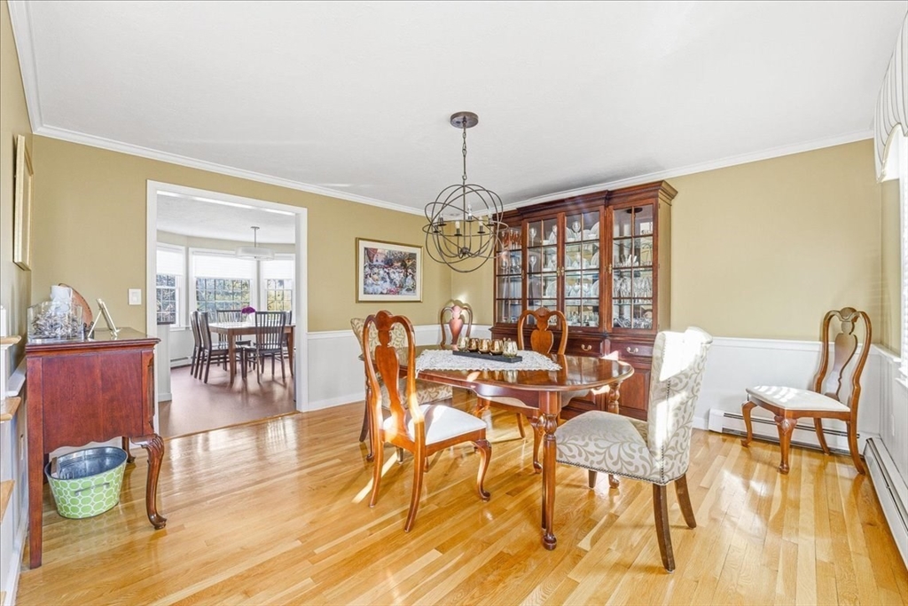 33 1st Parish Lane Hanover, MA 02339 - Photo 16 of 35 a dining room with furniture a chandelier and wooden floor