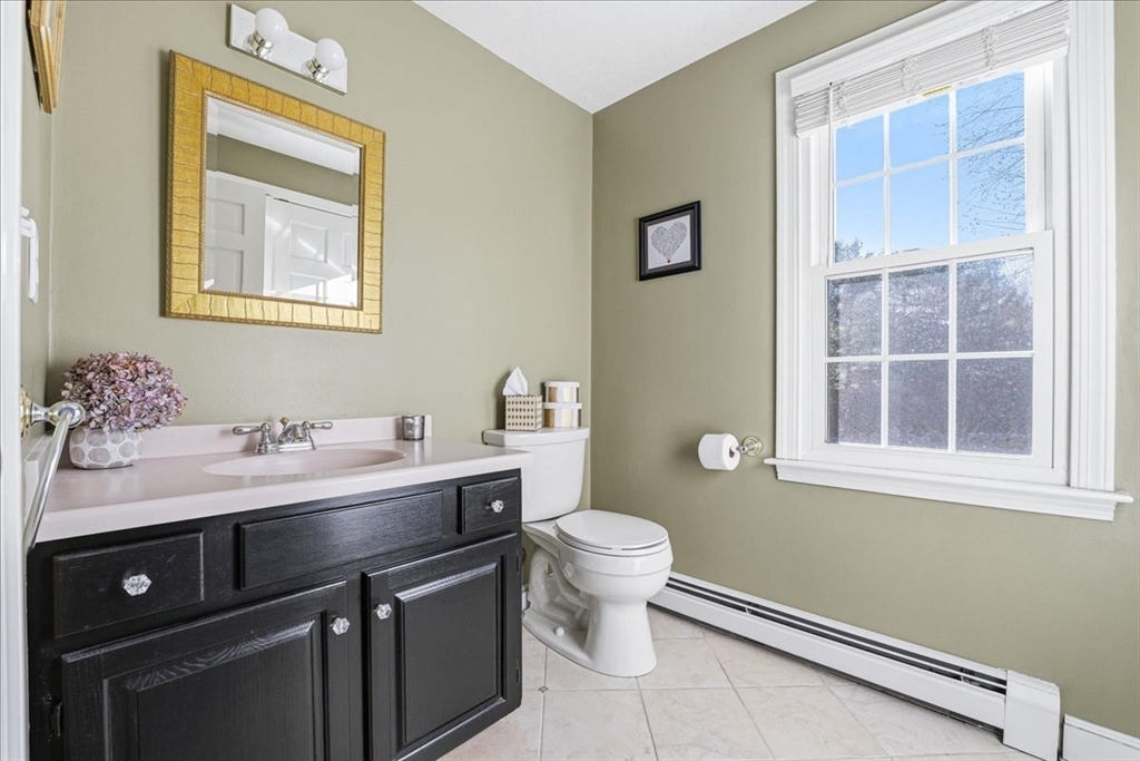 33 1st Parish Lane Hanover, MA 02339 - Photo 19 of 35 a bathroom with a sink a toilet and a window