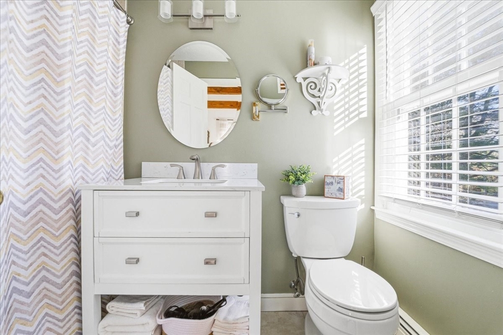 33 1st Parish Lane Hanover, MA 02339 - Photo 22 of 35 a bathroom with a toilet a sink a mirror and bathtub