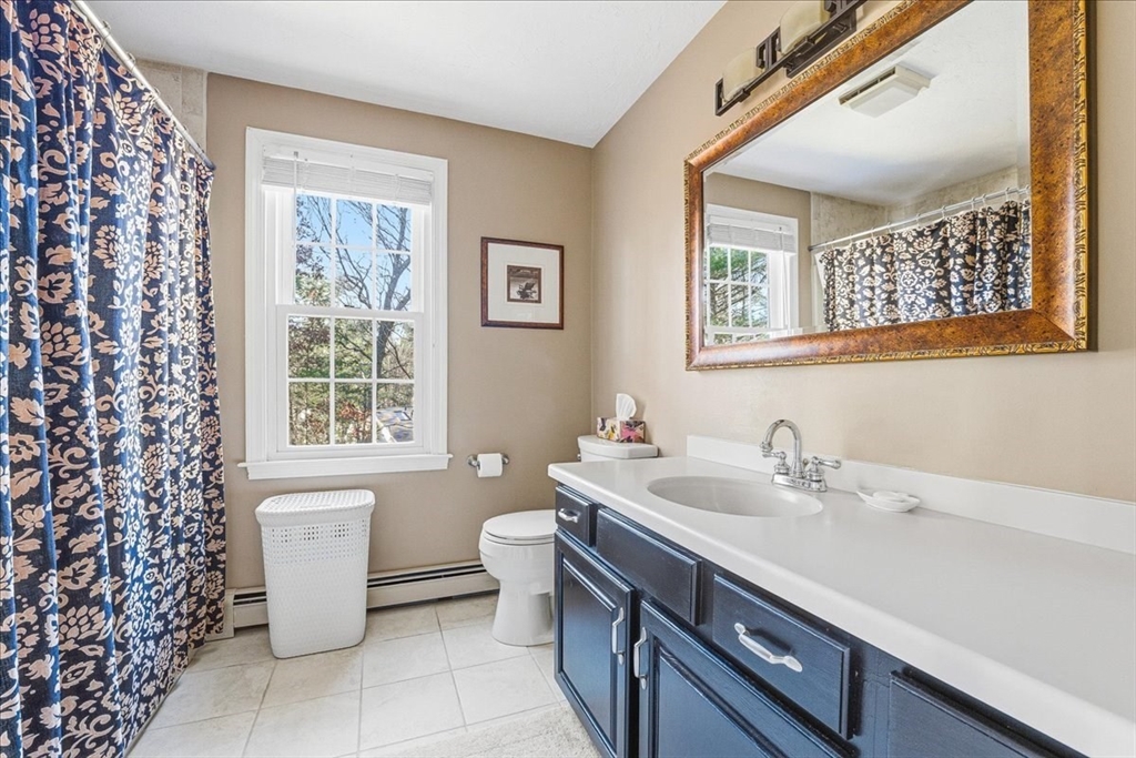33 1st Parish Lane Hanover, MA 02339 - Photo 29 of 35 a bathroom with a sink toilet and a mirror