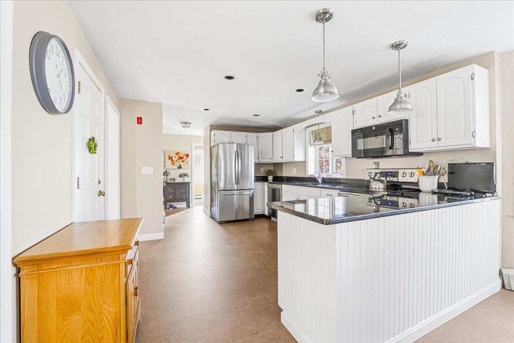 33 1st Parish Lane Hanover, MA 02339 - Photo 5 of 35 a kitchen with stainless steel appliances granite countertop a sink a stove and a refrigerator
