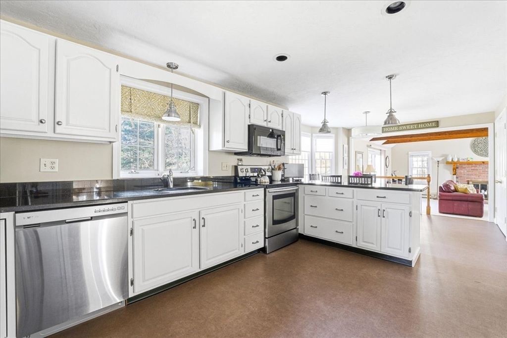 33 1st Parish Lane Hanover, MA 02339 - Photo 6 of 35 a kitchen with granite countertop white cabinets and white appliances