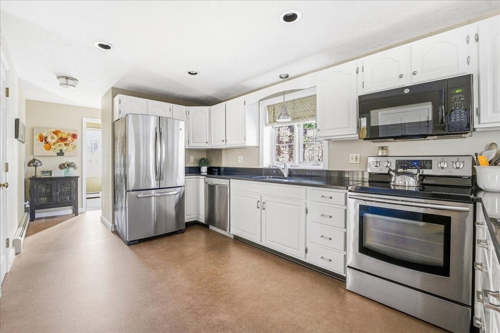 33 1st Parish Lane Hanover, MA 02339 - Photo 7 of 35 a kitchen with stainless steel appliances a stove microwave and refrigerator