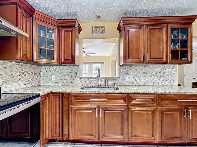 a kitchen with stainless steel appliances granite countertop cabinets and window