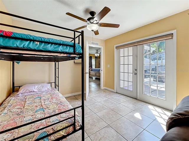 a bedroom with a bed and a large window