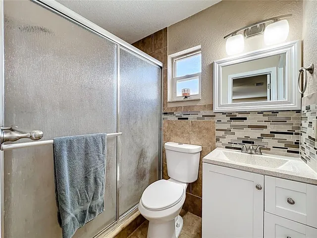 a bathroom with a toilet a sink and a mirror