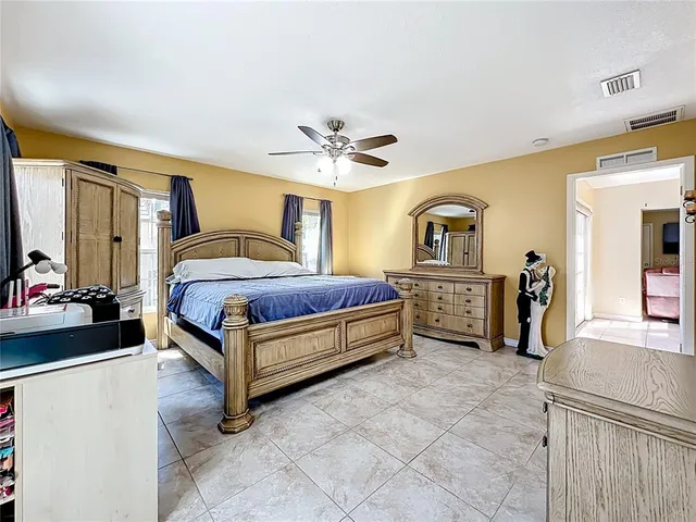 a living room with a bed and a chandelier