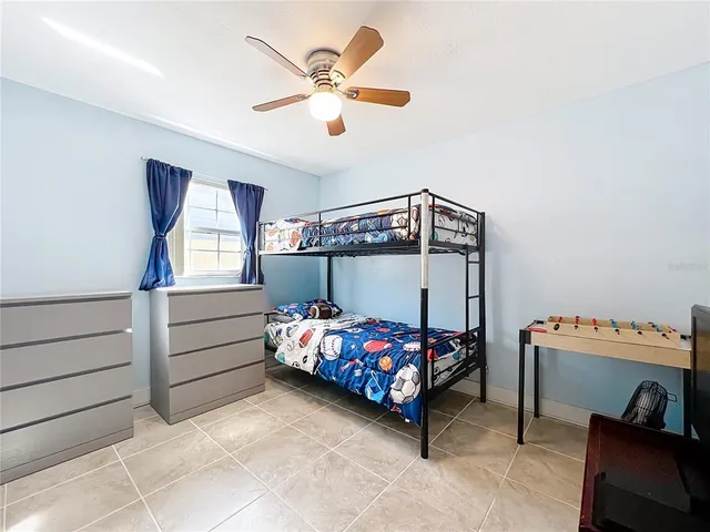 a bedroom with a bed and a baby bed