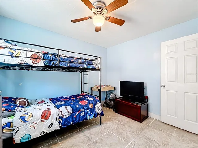 a bedroom with a bed and a tv