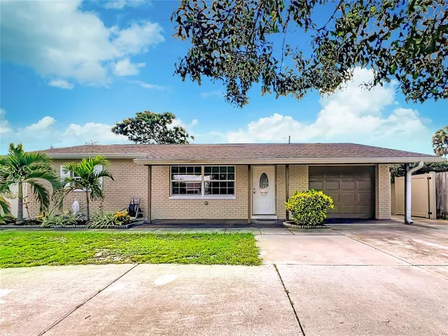 a front view of a house with a garden and plants