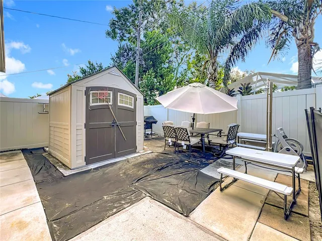 a view of a chairs and table under an umbrella in patio