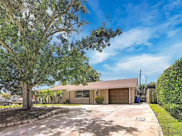 a view of a house with a tree in front