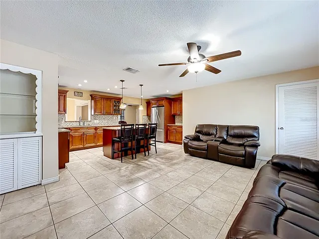 a living room with furniture and kitchen view