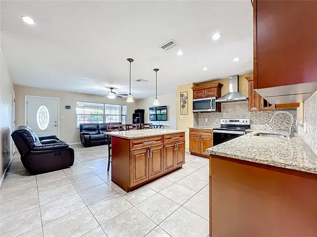 a kitchen with stainless steel appliances granite countertop a sink and cabinets