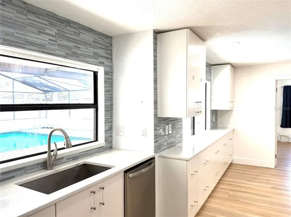 a kitchen with granite countertop a sink and a window