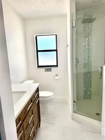 a bathroom with a toilet sink and shower