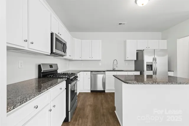 a view of walk in closet with white cabinet