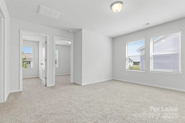 an empty room with windows and closet