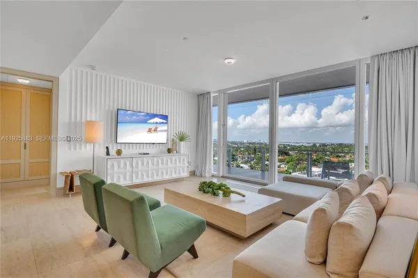 a living room with furniture and a large window