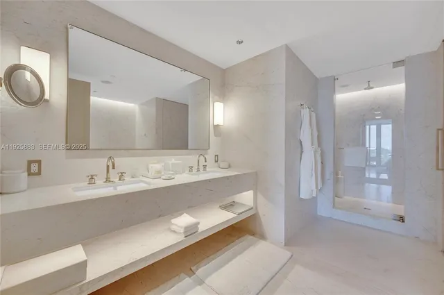 a bathroom with a double vanity sink mirror and shower