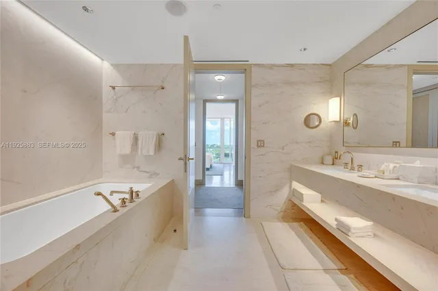 a spacious bathroom with a tub sink shower and mirror