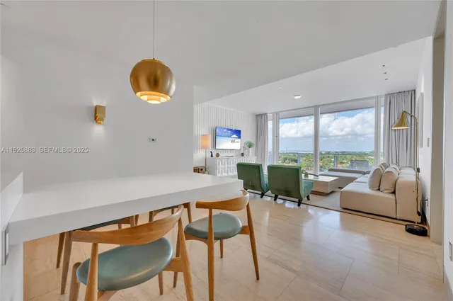 a living room with fireplace furniture and a large window