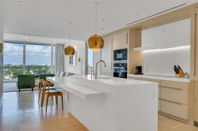 a kitchen with a table chairs stove and wooden floor