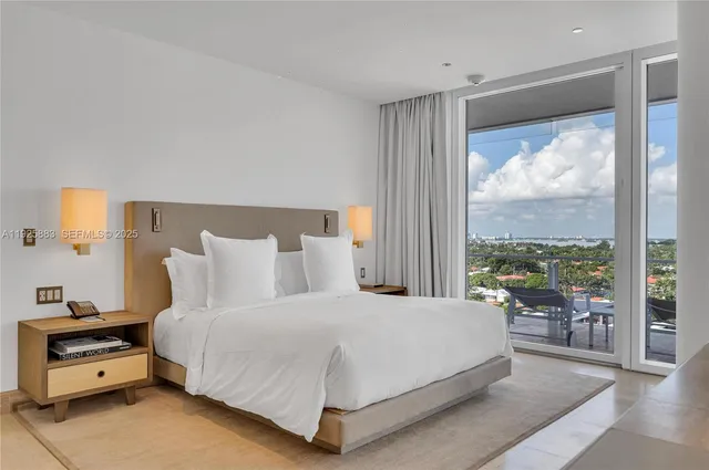 a bedroom with a bed and large window