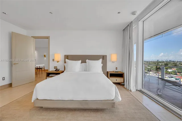 a bedroom with a bed and large window