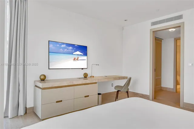 a bedroom with a bed and a table