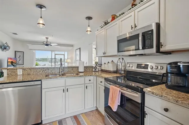 a view of an ocean with a table chairs and a fire pit