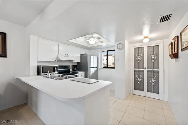 a view of a kitchen with cabinets and wooden floor