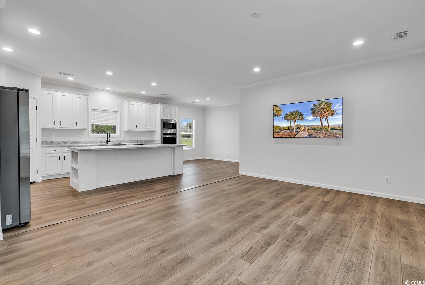 1529 Bucksport Road Conway, SC 29527 - Photo 11 of 31 Kitchen with crown molding, white cabinets, recessed lighting, appliances with stainless steel finishes, and a center island