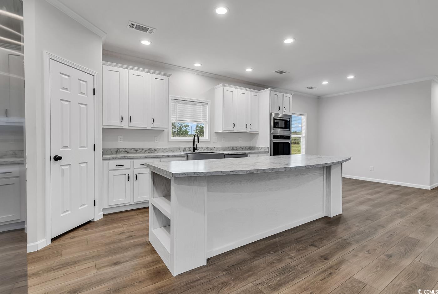 1529 Bucksport Road Conway, SC 29527 - Photo 12 of 31 Kitchen featuring a center island, crown molding, recessed lighting, white cabinets, and stainless steel appliances
