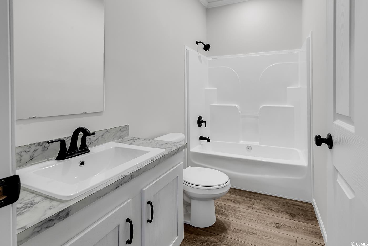 1529 Bucksport Road Conway, SC 29527 - Photo 21 of 31 Full bath featuring dark wood-style flooring, bathtub / shower combination, vanity, and ornamental molding
