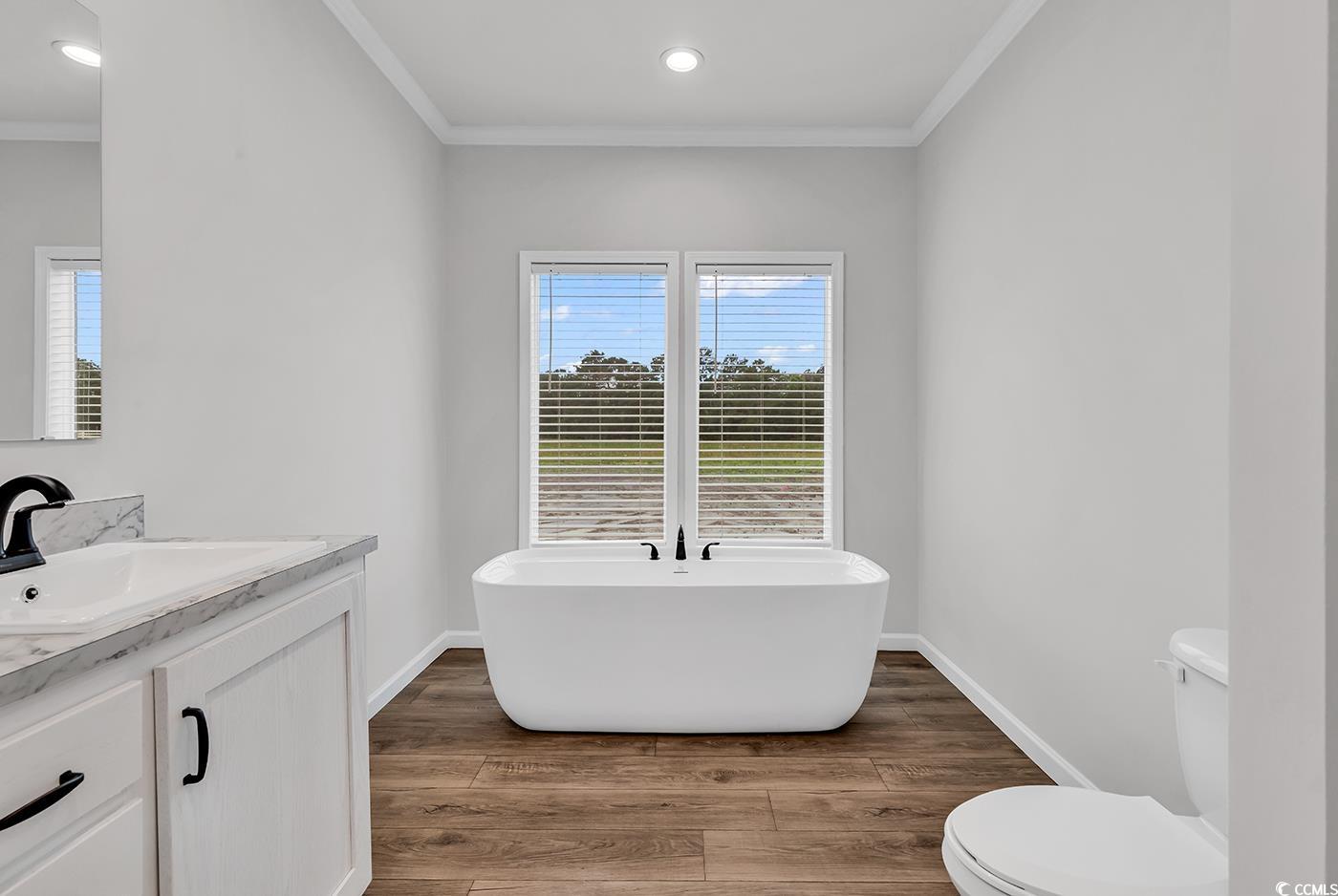 1529 Bucksport Road Conway, SC 29527 - Photo 29 of 31 Full master bathroom with a freestanding tub, crown molding, light wood-type flooring, double vanity, and recessed lighting