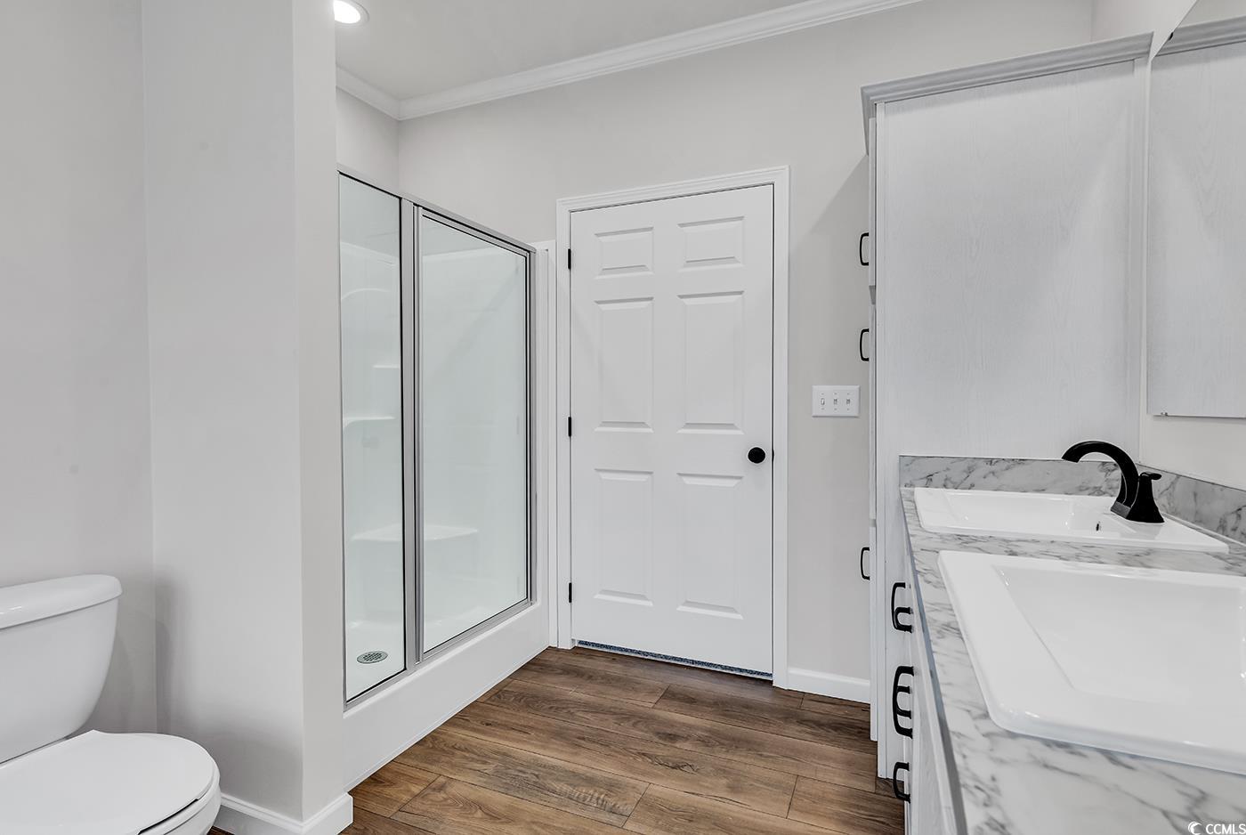 1529 Bucksport Road Conway, SC 29527 - Photo 30 of 31 Full master bathroom with a freestanding tub, vanity, light wood-style flooring, ornamental molding, and recessed lighting