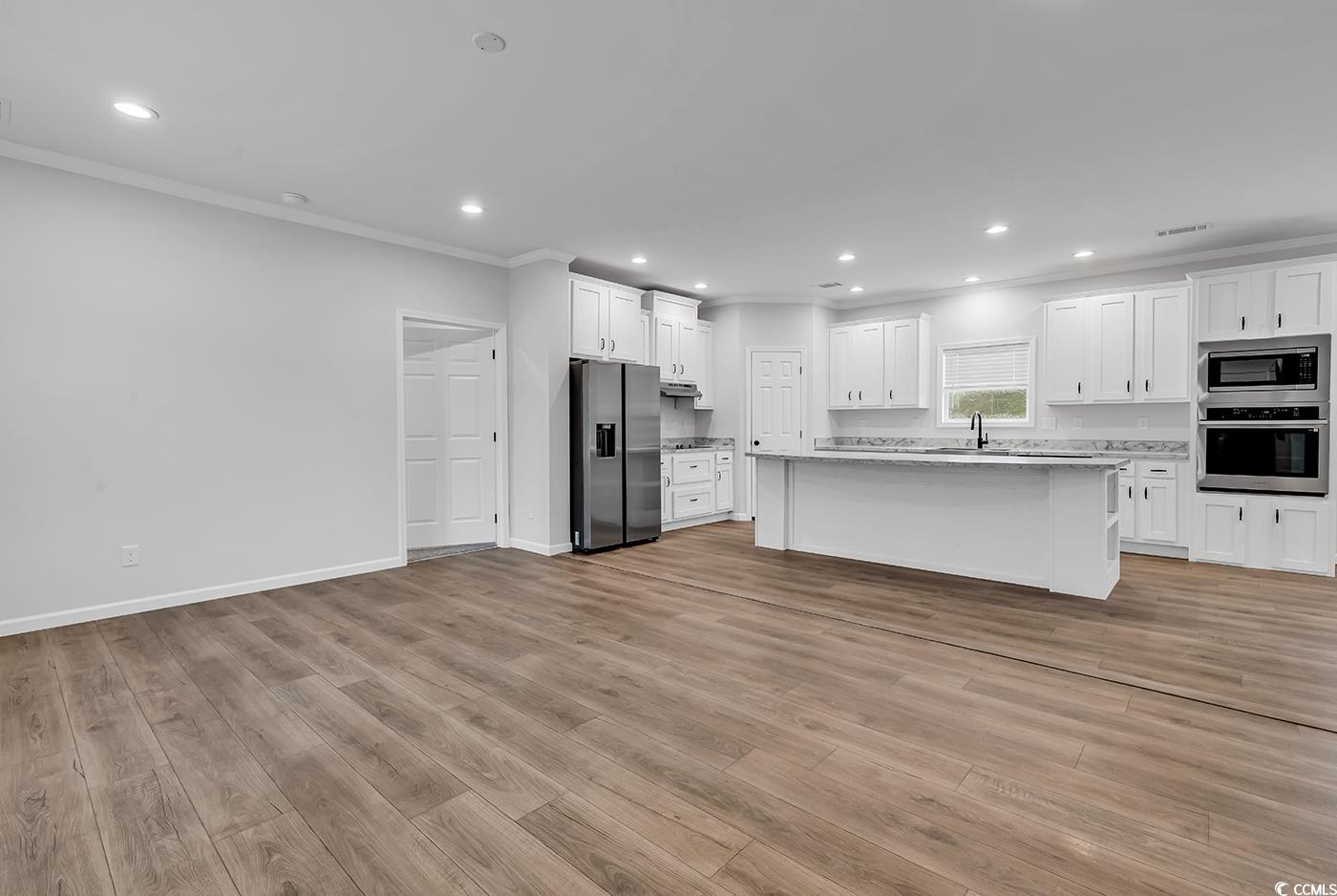 1529 Bucksport Road Conway, SC 29527 - Photo 6 of 31 Kitchen with crown molding, white cabinetry, recessed lighting, a kitchen island, and stainless steel appliances