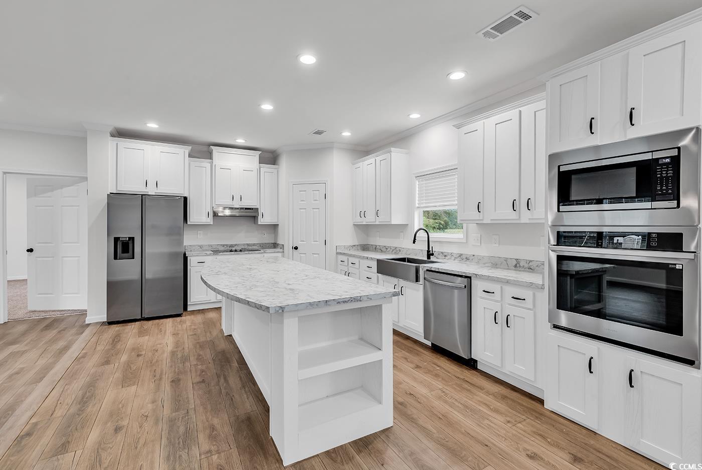1529 Bucksport Road Conway, SC 29527 - Photo 7 of 31 Kitchen featuring crown molding, white cabinetry, recessed lighting, appliances with stainless steel finishes, and a center island
