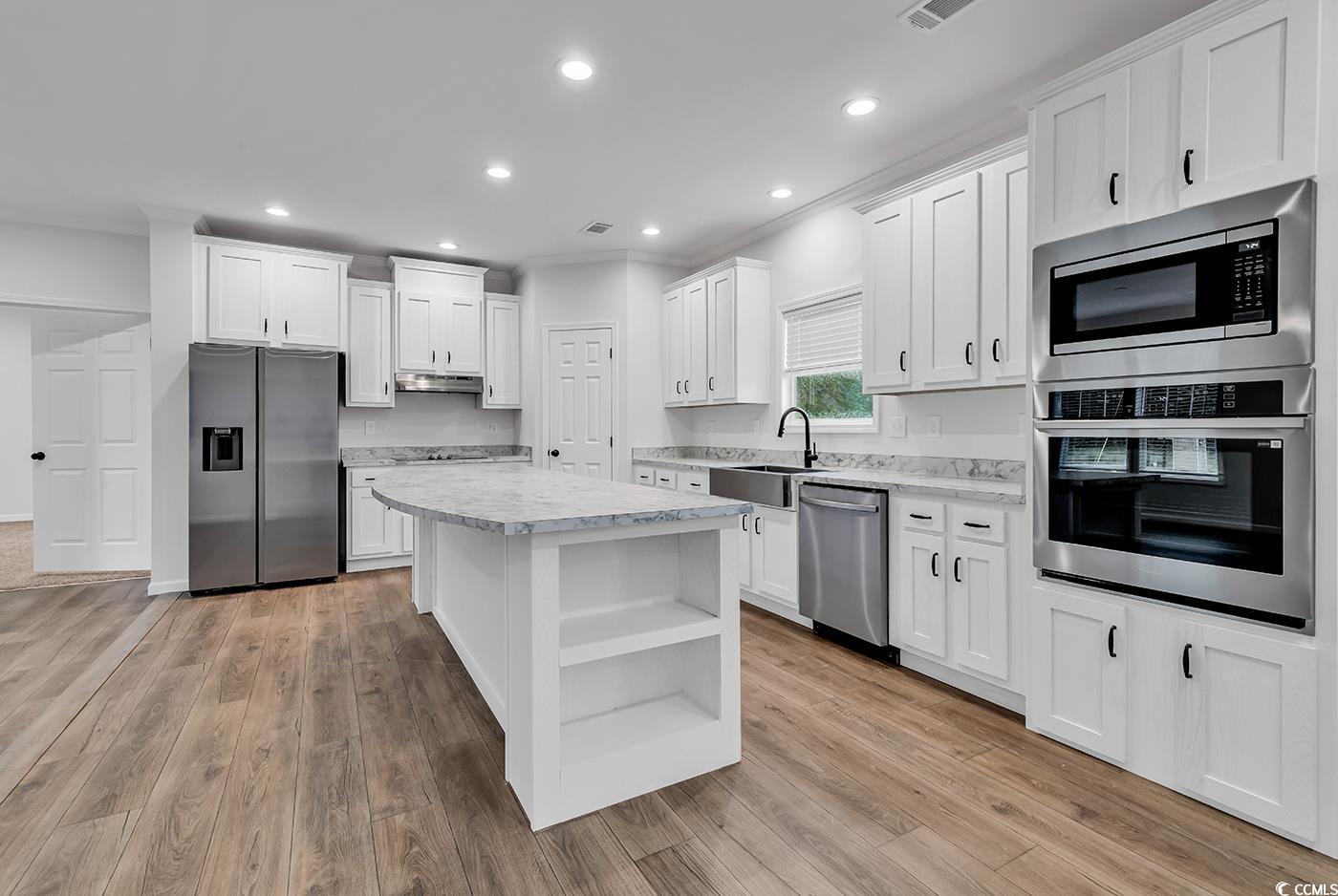 1529 Bucksport Road Conway, SC 29527 - Photo 9 of 31 Kitchen featuring stainless steel appliances, ornamental molding, recessed lighting, white cabinetry, and a kitchen island